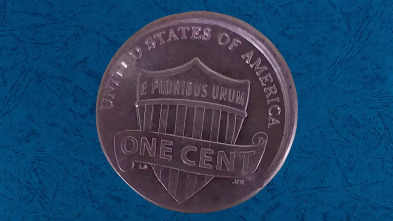 2013 penny off-center strike error with visible blank planchet crescent and date still readable
