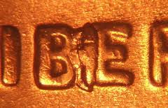 2013 penny BIE die crack error showing vertical crack between B and E in LIBERTY resembling the letter I